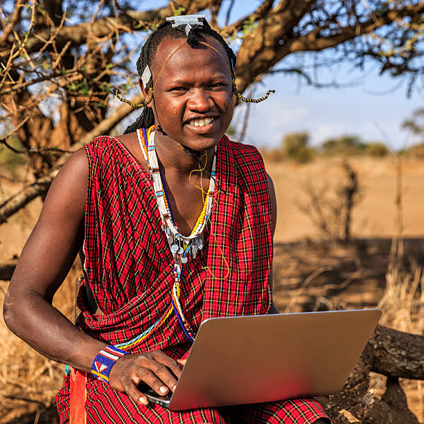 A man smiling with a laptop